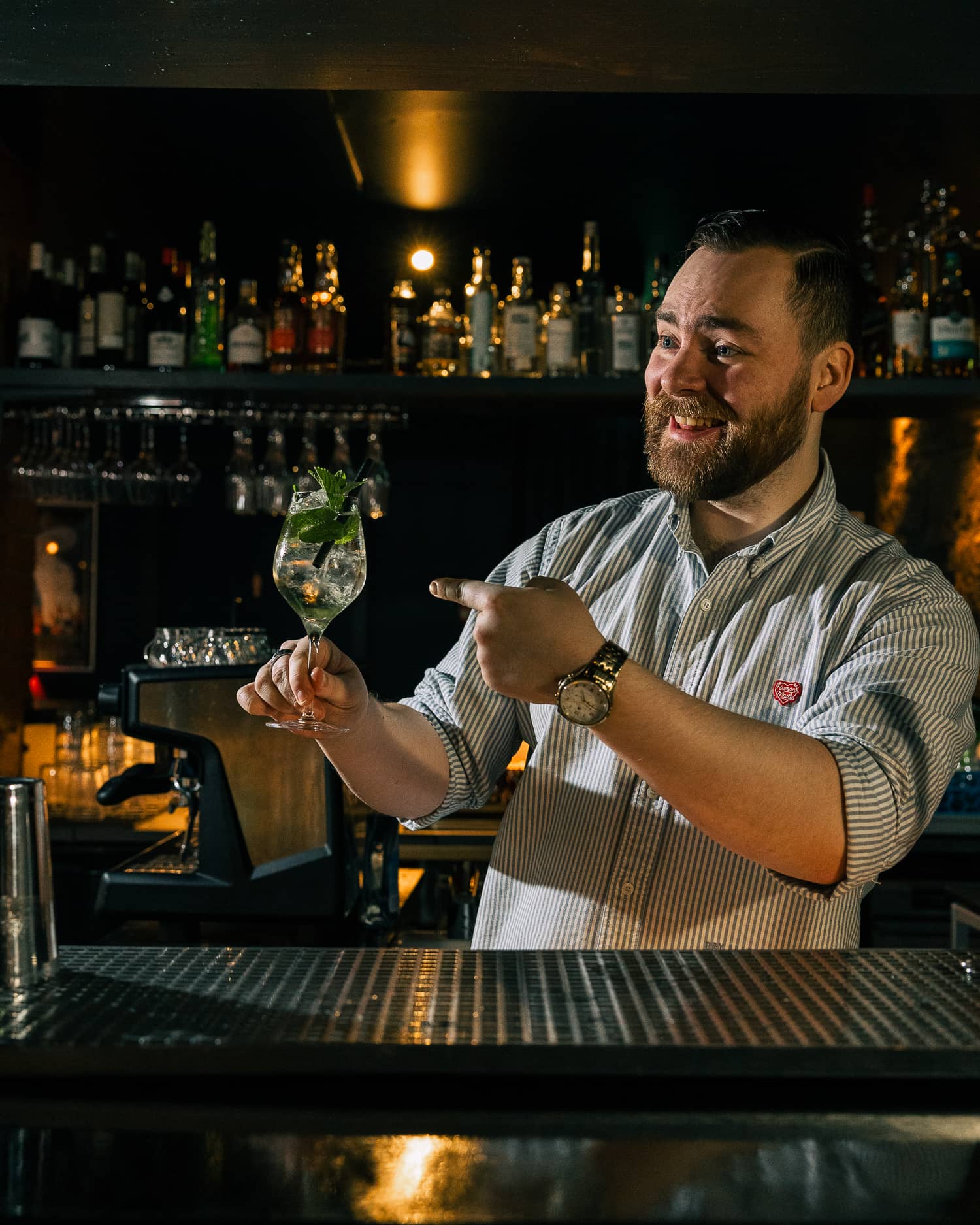 A bartender at Daisy points to a nice looking cocktail